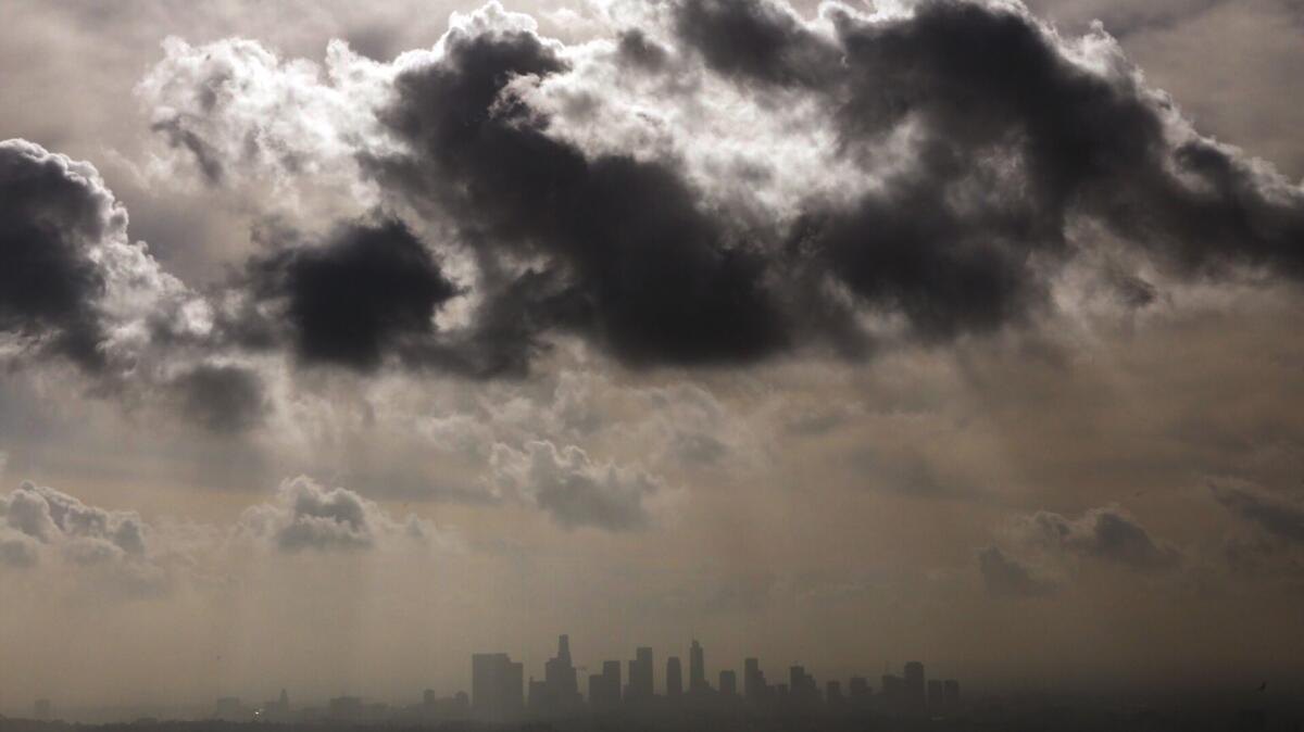 Rain clouds pass over downtown Los Angeles on Monday bringing scattered showers.