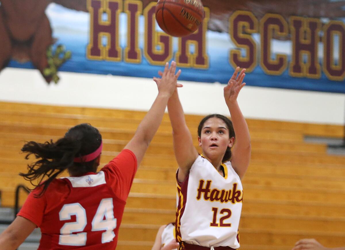 Ocean View's Emma Beard (12) shoots a jumper over the hand of Santa Ana's Evelyn Torres in a Hawk Holiday Classic game on Tuesday.