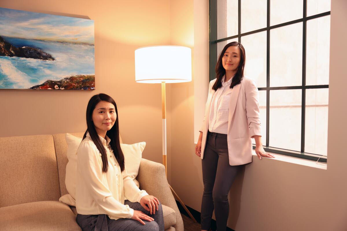 Korean psychotherapists Soojin Lee, left, and Linda Yoon, right, pose for a portrait.