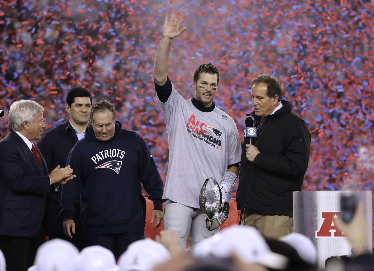 New England quarterback Tom Brady celebrates next to Jim Nantz after leading the Patriots to victory.