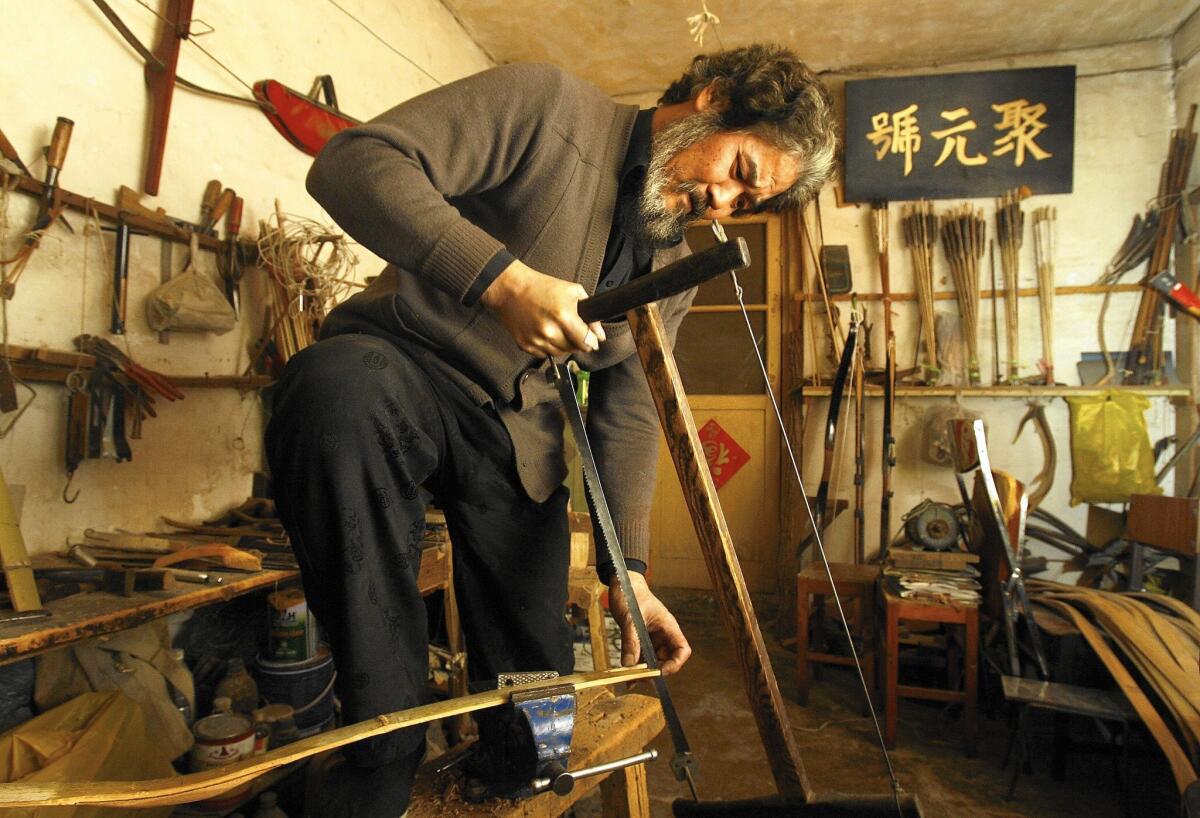 Yang Fuxi makes about 100 bows a year at his Beijing shop. He's taught his son to continue a family business that dates to the 1700s.