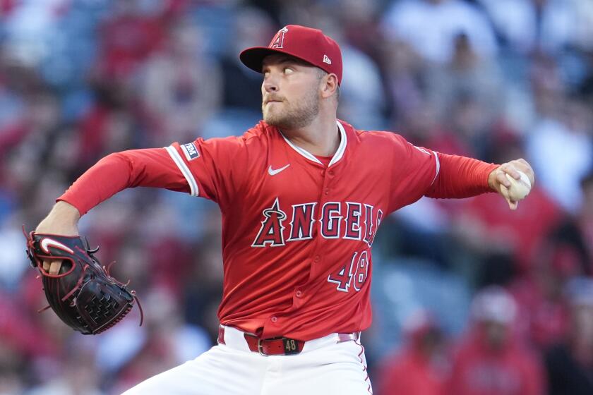 Los Angeles Angels starting pitcher Reid Detmers throws to a Boston Red Sox batter.