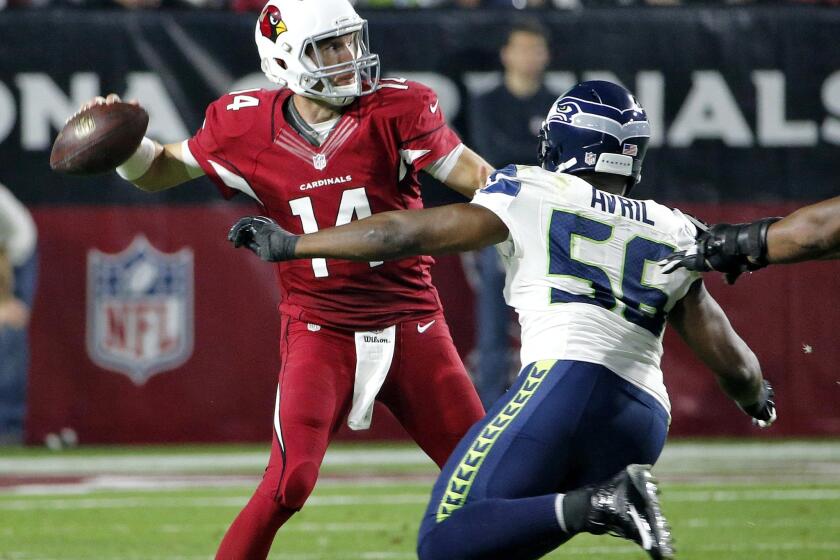 Cardinals quarterback Ryan Lindley passes under pressure from Seahawks defensive end Cliff Avril in the second half of their game last week.