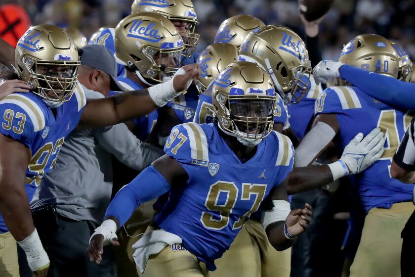 PASADENA, CALIF. - SEP. 4, 2021. UCLA players celebrate a turnover by LSU at the Rose Bowl on Saturday, Sept. 4, 2021. (Luis Sinco / Los Angeles Times)