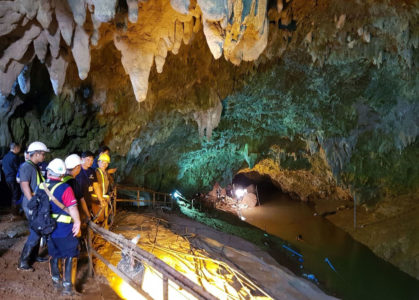 Thai workers attempt to drain the water from the cave during the search and rescue operation.
