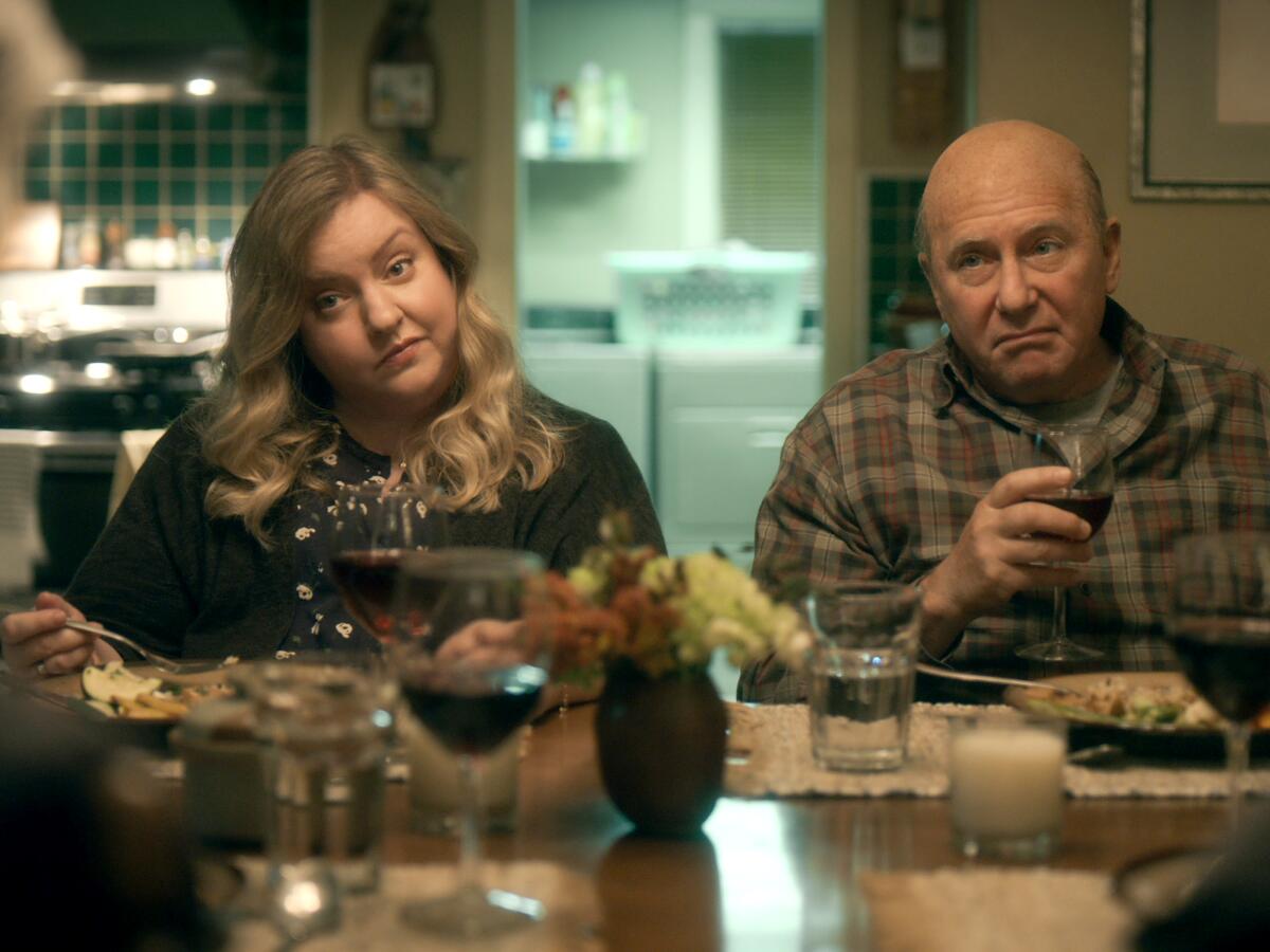 Sarah Baker and Paul Reiser react to dinner conversation in a scene from "The Kominsky Method."