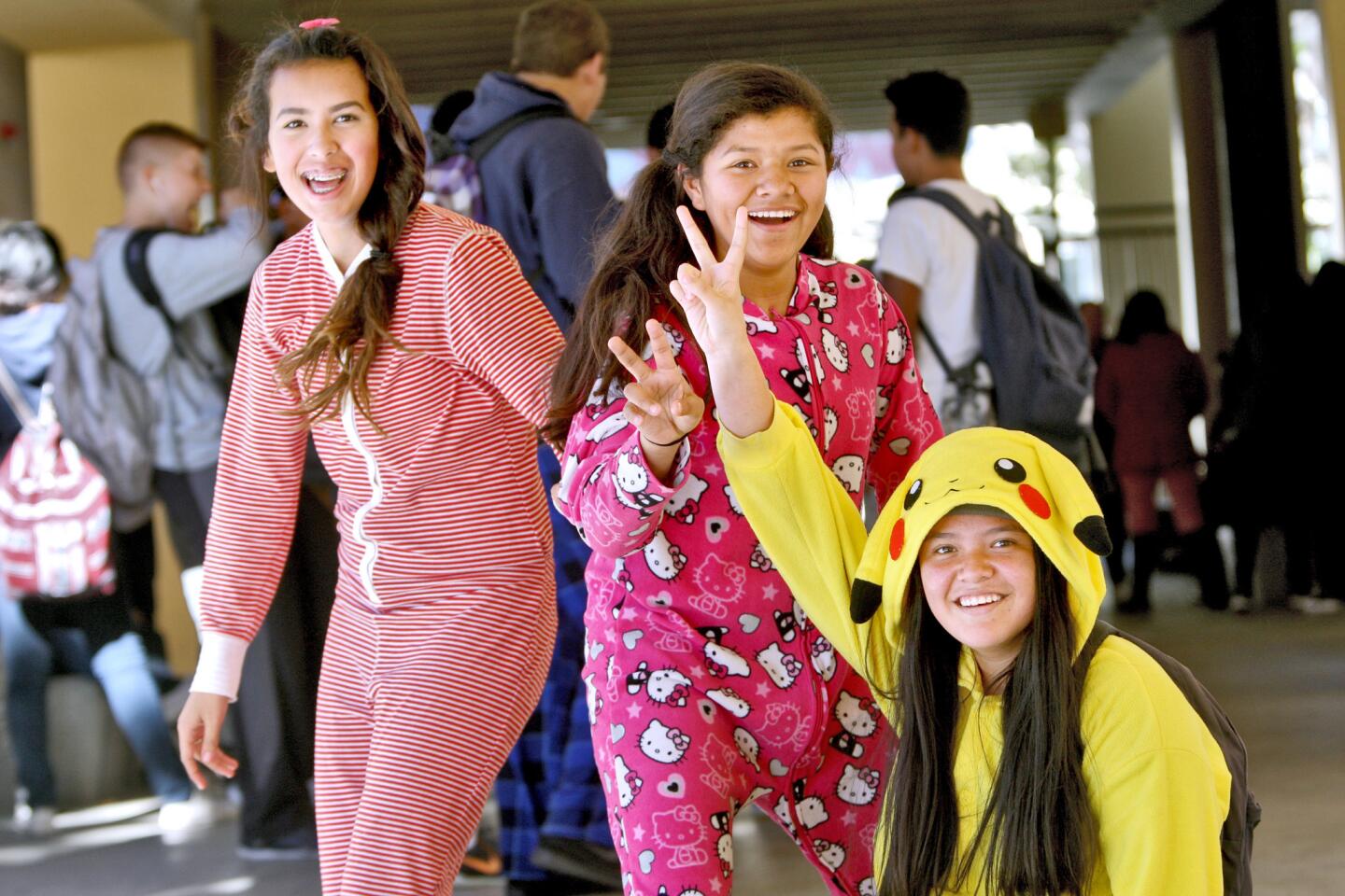 Freshmen girls Sarah Whittle, 14, left, Jazmin Bernal, 14, center, and Ingrid Alas, 15, right, strike a pose showing off their pajamas during Spirit Day at Glendale High School in Glendale on Thursday, November 5, 2015.