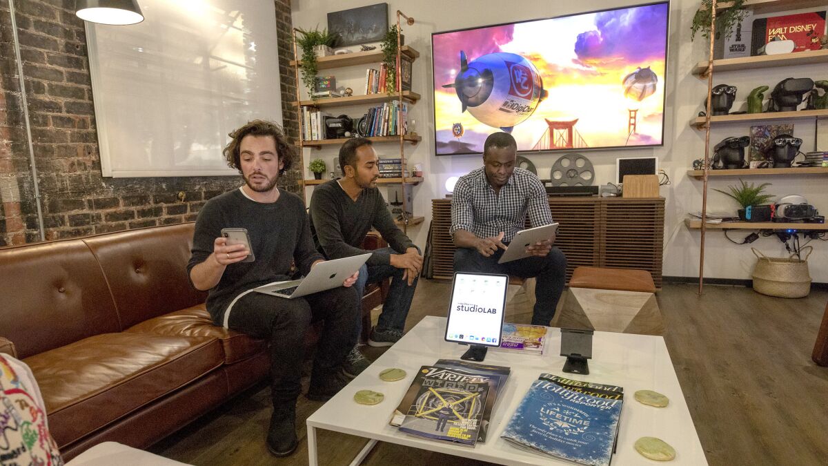 Members of the StudioLab team gather at the living room demo space, which is used as a collaboration area.