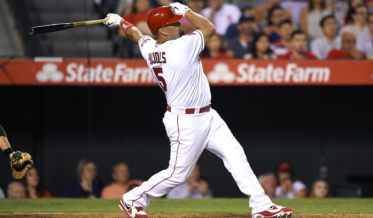 Angels' Albert Pujols follows through on a walk-off two-run home run against the Oakland Athletics on Wednesday.
