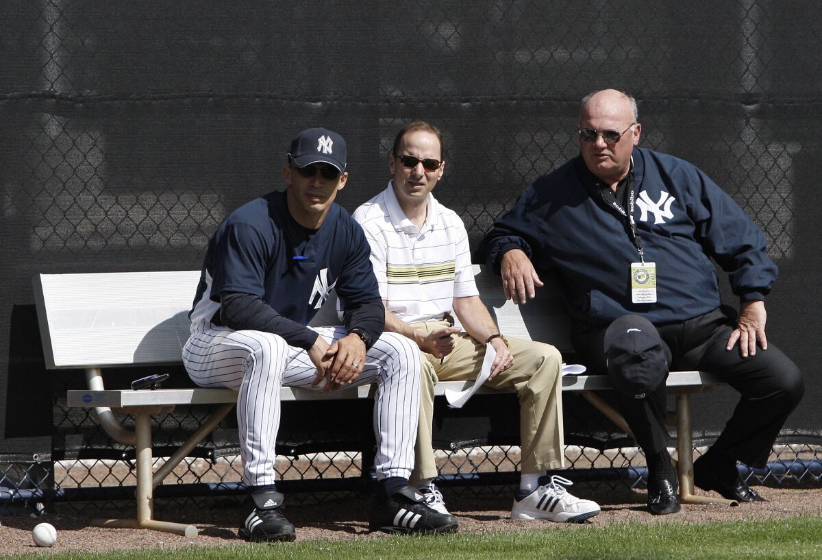 New York Yankees manager Joe Girardi, left, sits with general manager Brian Cashman, center, and senior vice president of baseball operations Mark Newman while watching spring training baseball workouts Friday, Feb. 15, 2008 in Tampa, Fla. Newman, a key front office executive for the New York Yankees during their run of five World Series titles from 1996 through 2009, was found dead Saturday, Sept. 12, 2020 at his home in Tampa, Fla. He was 71. (AP Photo/Julie Jacobson)