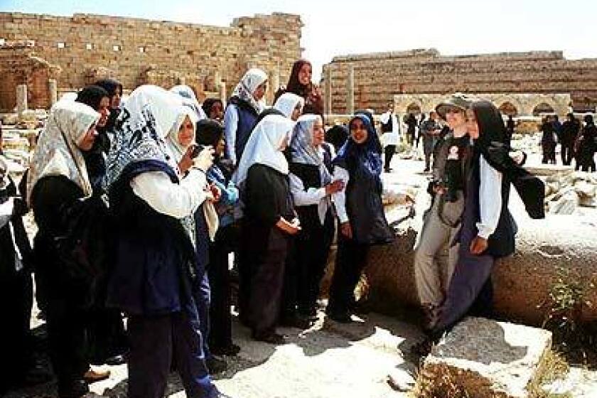 Libyan schoolgirls with a Western tourist at Leptis Magna ruin, included on many cruise itineraries.