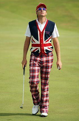 Ian Poulter of England wears a sweater vest with a Union Jack design and bold plaid pants as he walks across the course during round one of the 138th British Open Championship at Turnberry golf club in Turnberry, Scotland.