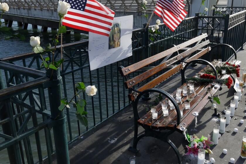 Flowers and a portrait of Kate Steinle remain at a memorial site on Pier 14 Friday, Dec. 1, 2017, in San Francisco. In this fiercely liberal city, city leaders remained attached to San Francisco's sanctuary city status despite a not guilty verdict in a killing that sparked feverish immigration debates because the man who fired the gun was in the country illegally after being deported five times. (AP Photo/Ben Margot)