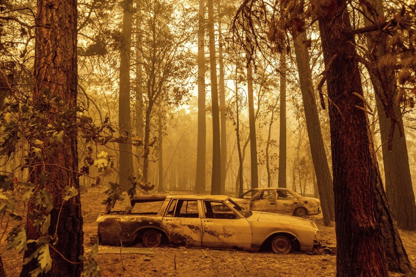 Scorched cars are left behind after the Dixie fire blazed through of Plumas County