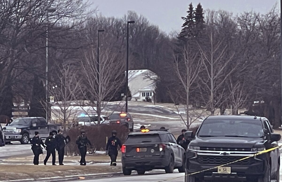 Police are seen walking from Park Plaza Apartments Saturday, Feb. 5, 2022 where there was a shooting in Brown Deer, Wis. Police say two people were killed and two more were injured in a shooting at an apartment complex in the Milwaukee suburb. (Ebony Cox /Milwaukee Journal-Sentinel via AP)