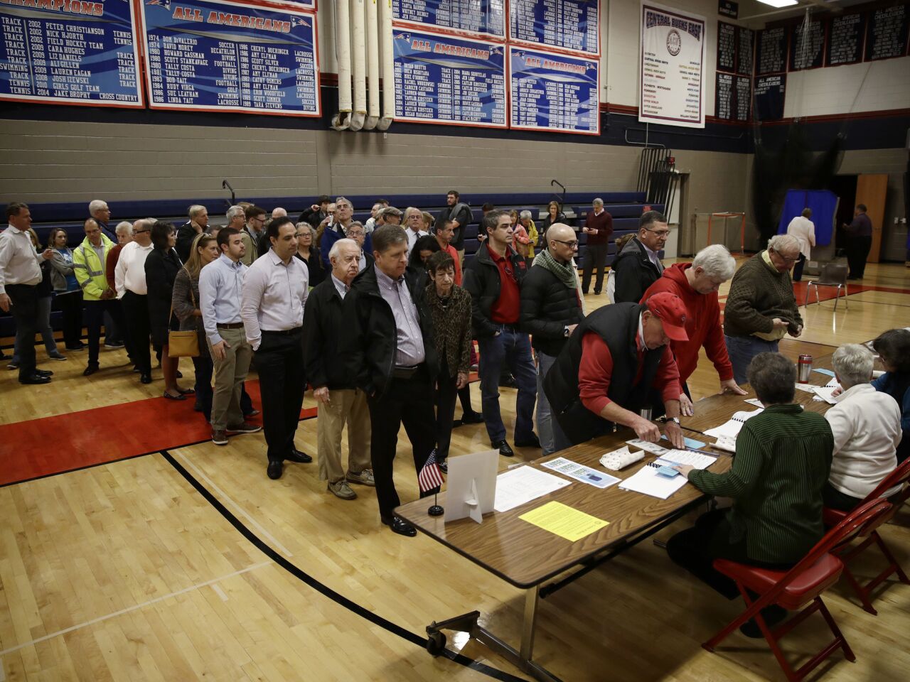 Voters line up to vote at a polling place in Doylestown, Pa.