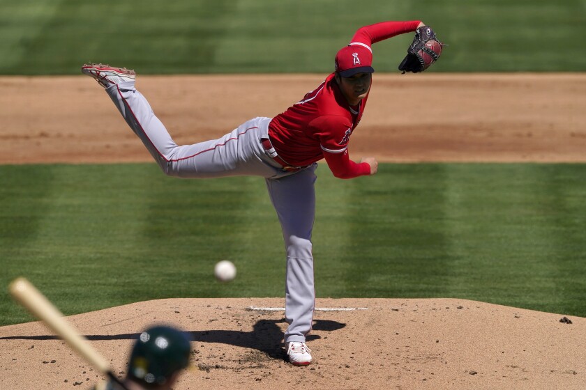 Los Angeles Angels pitcher Shohei Ohtani (17) throws against the Oakland Athletics during the first inning of a spring training baseball game, Friday, March 5, 2021, in Mesa, Ariz. (AP Photo/Matt York)