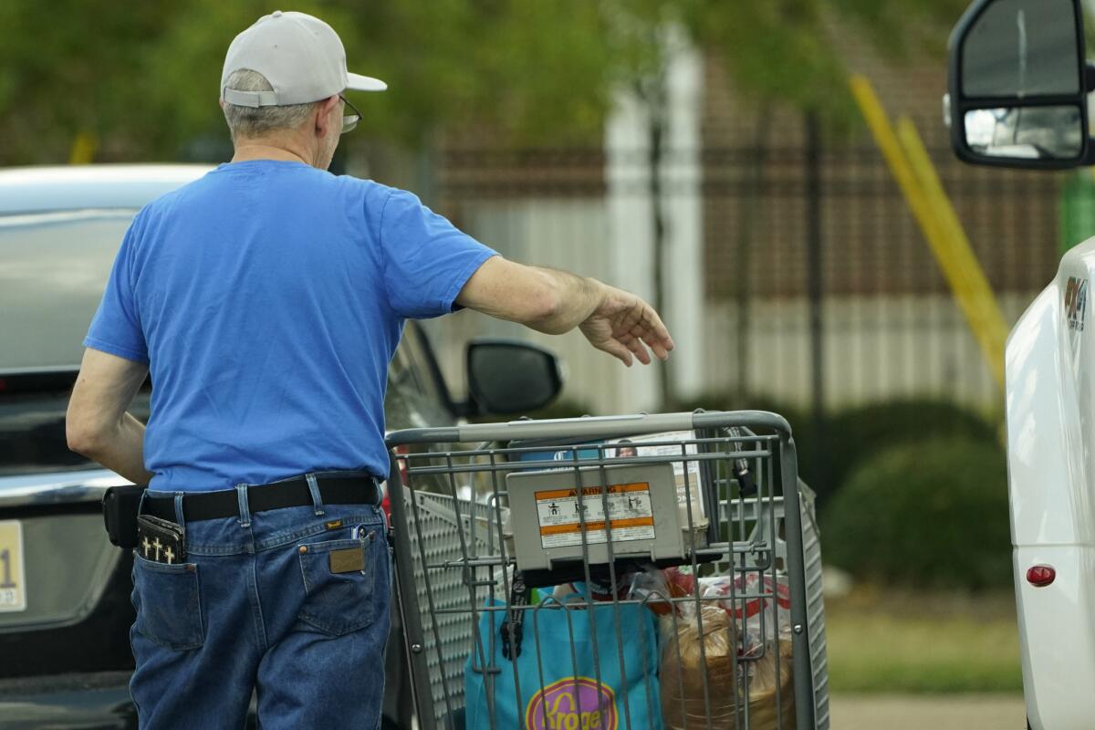 A shopper removes his purchases from his cart in Jackson, Miss., on Wednesday.