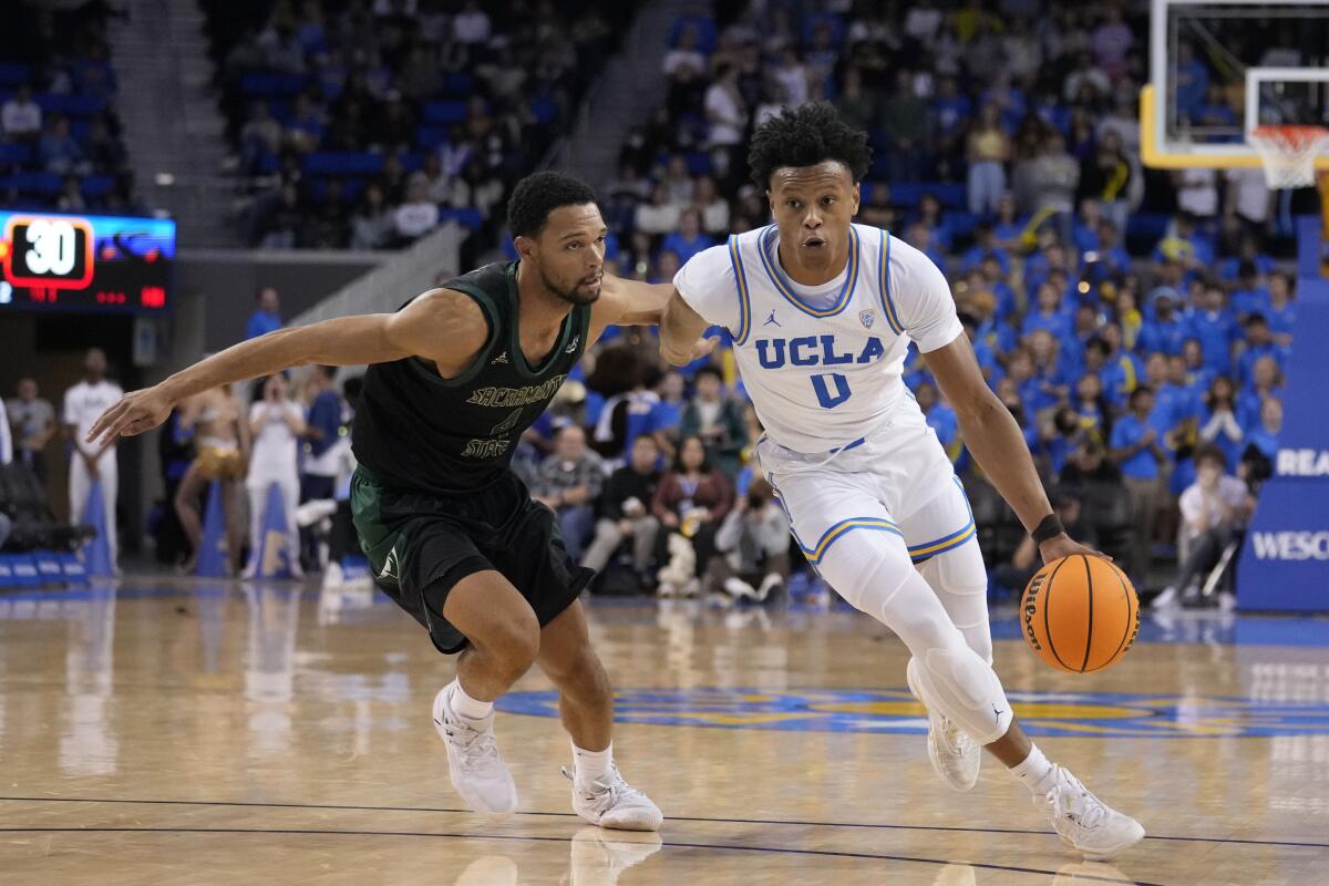 UCLA guard Jaylen Clark dribbles past Sacramento State guard Zach Chappell.