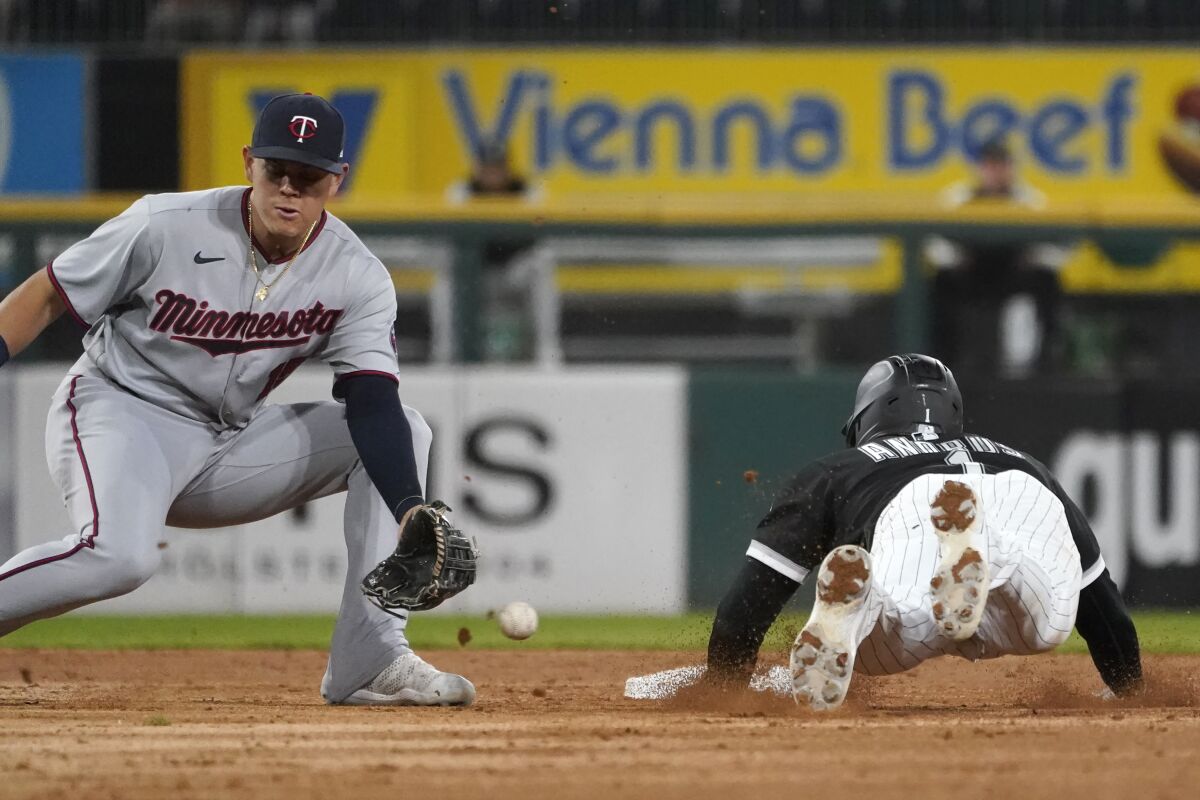 Chicago White Sox's Elvis Andrus, right, steals second as Minnesota Twins' Gio Urshela is unable to handle the throw from catcher Ryan Jeffers during the third inning of a baseball game Tuesday, Oct. 4, 2022, in Chicago. (AP Photo/Charles Rex Arbogast)