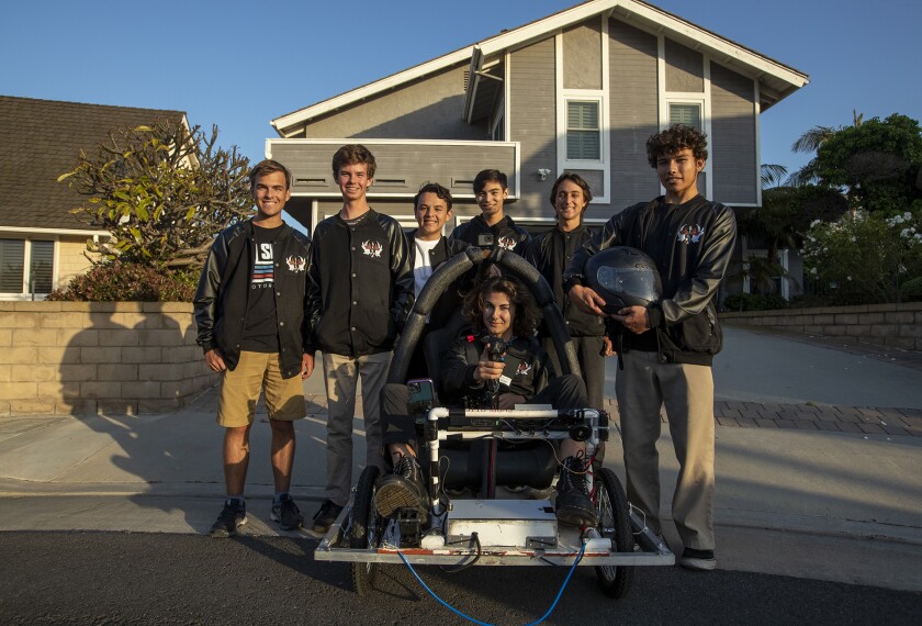 The Huntington Beach High School Oilers electric race car team poses for a picture Wednesday.