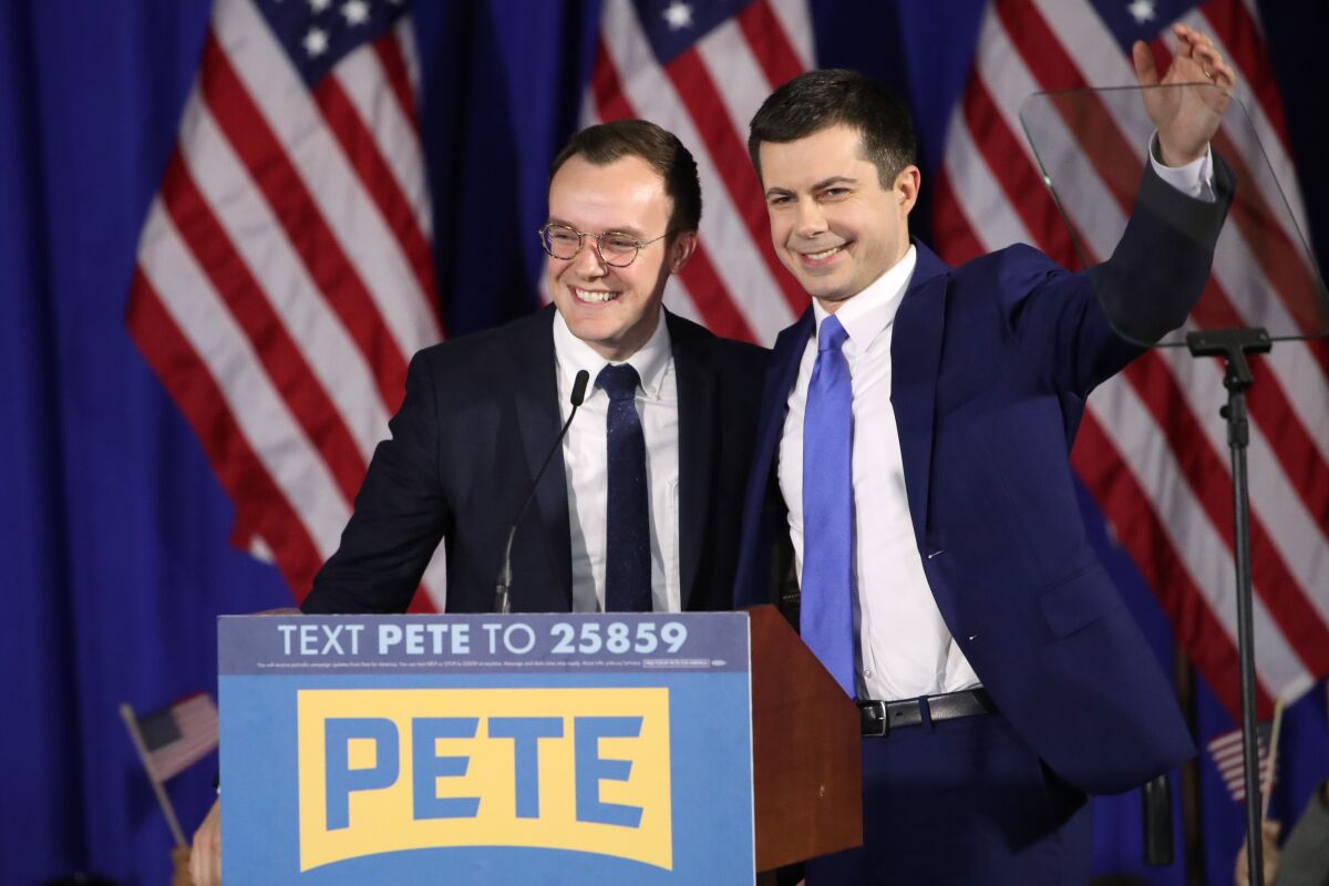 FILE - In this Feb. 11, 2020, file photo Democratic presidential candidate former South Bend, Ind., Mayor Pete Buttigieg acknowledges supported as he stands on stage with his husband Chasten Buttigieg at a primary night election rally in Nashua, N.H. Transportation Secretary Pete Buttigieg has announced that he and husband Chasten have become parents. Buttigieg, the first openly gay Cabinet secretary confirmed by the Senate, posted a photo of their two children on Saturday, Sept. 4, 2021, on his personal Twitter account. (AP Photo/Mary Altaffer, File)