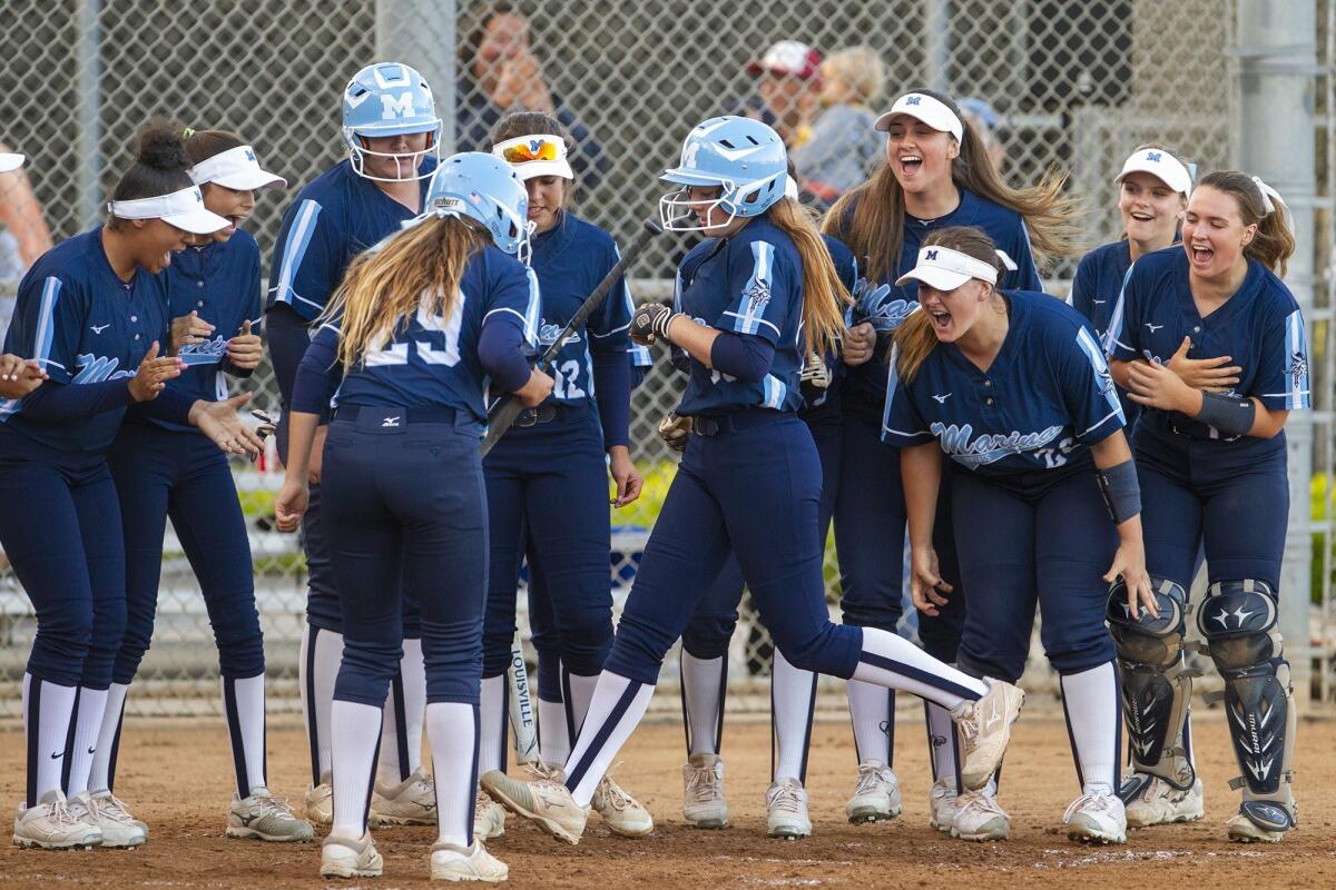 Marina High's Taylor Lane touches home after hitting a two-run home run in the third inning of a Surf League game at Huntington Beach on Tuesday.