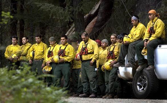 PAYING THEIR RESPECTS: Crews battling on a front of the Iron Complex fire in Shasta-Trinity National Forest take a two-minute moment of silence to honor those lost in Tuesday's helicopter crash, which federal officials are investigating. Four survived after the Sikorsky crashed and burst into flames after takeoff.