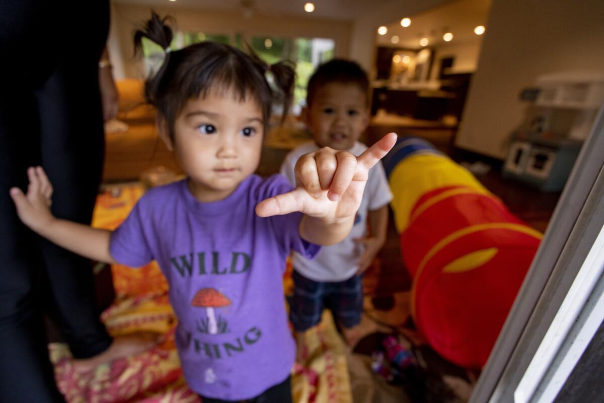 A Hawaiian child flashes a shaka hand sign.