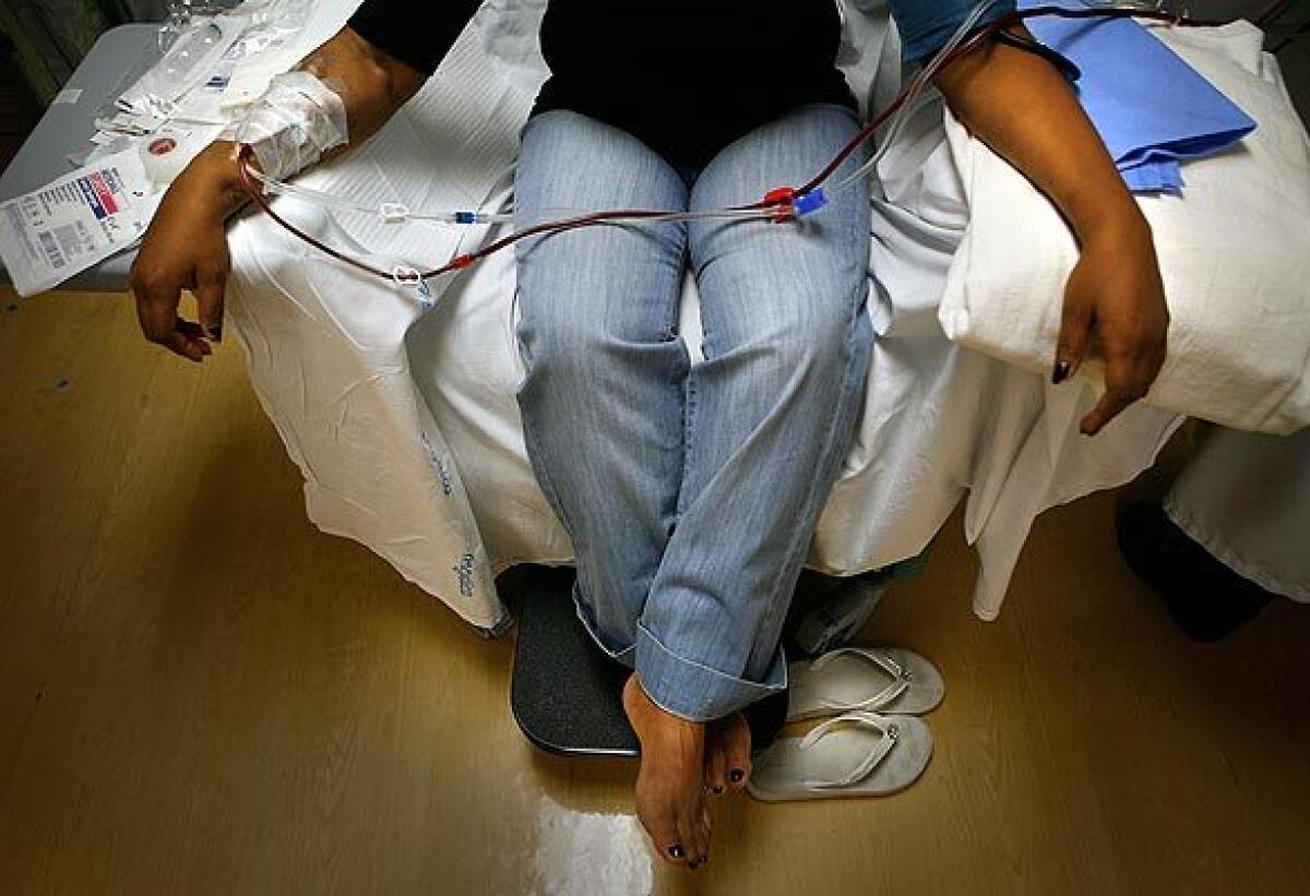 A patient is connected to a dialysis machine.