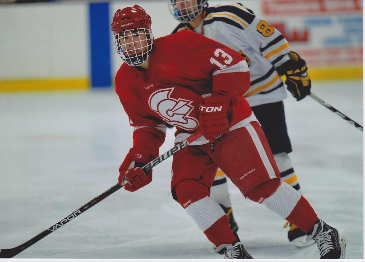 Jack Jablonski (13) skates with a stick in his hand during a youth hockey game