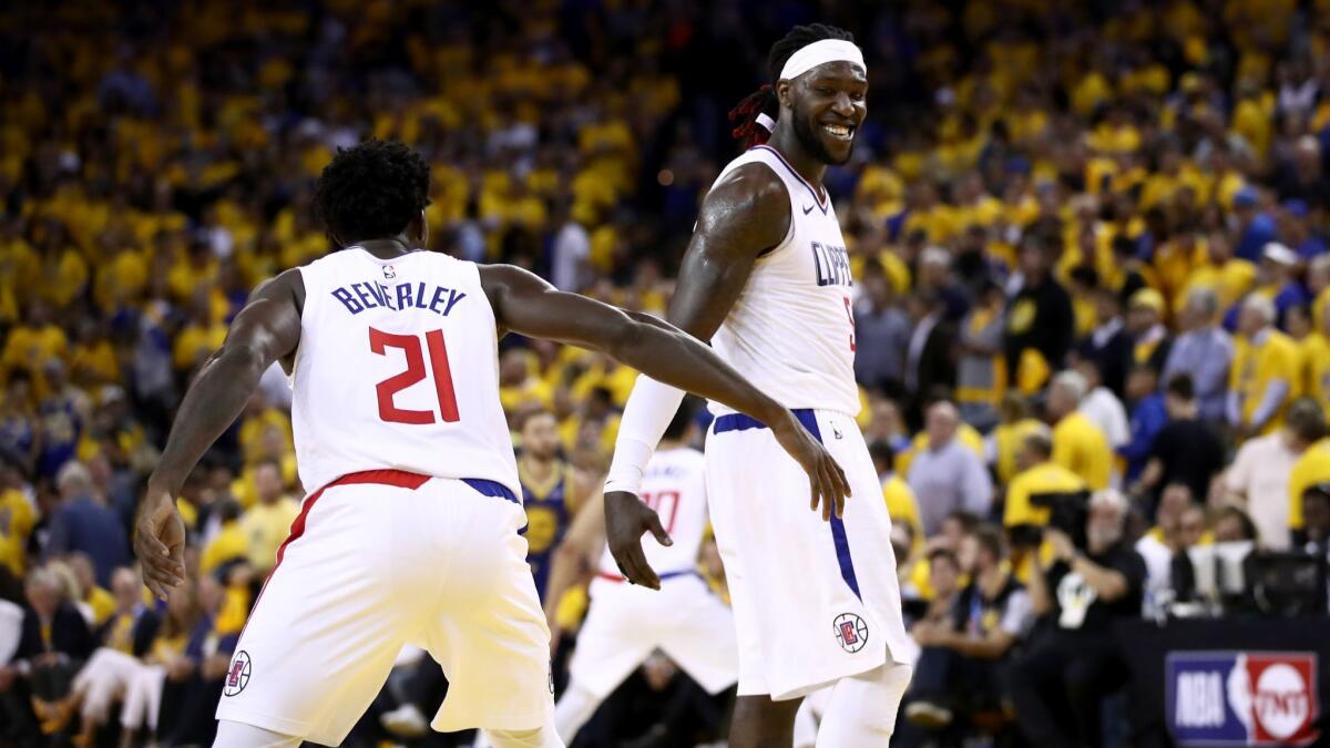 Clippers' Montrezl Harrell (5) shakes hands with Patrick Beverley (21) during their game against the Golden State Warriors in Game 5 of the first round of the NBA playoffs on Wednesday in Oakland.