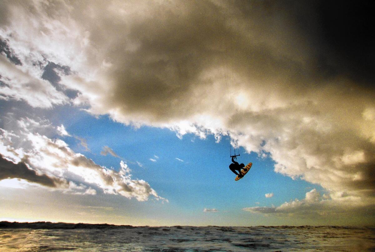Pro kiteboarder Adam Koch of Manhattan Beach flies above the ocean off Sunset Beach.