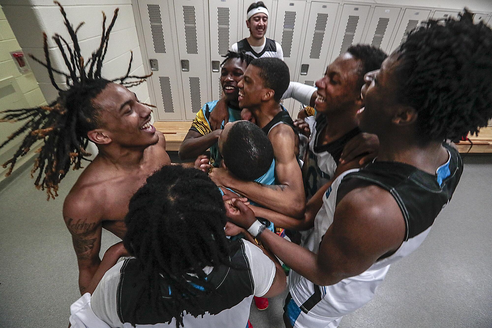 Flint players celebrate in the locker room after their win over Davison.