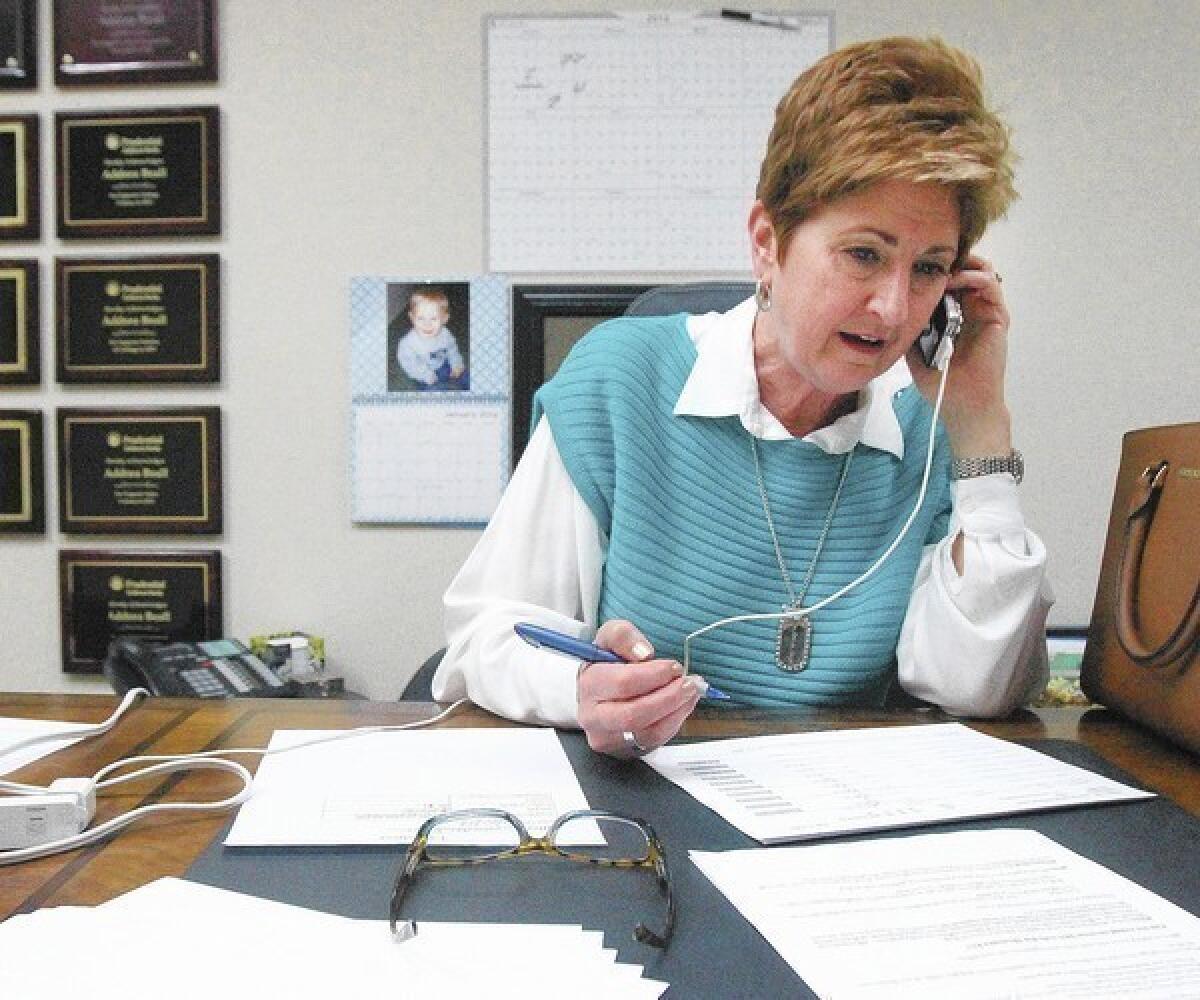 Former school board member Susan Boyd makes calls at a call center set up in the Prudential Realty Office's in La Cañada Flintridge on Tuesday, Jan. 21, 2014. They are calling La Cañadans to ask support for a local parcel tax for the school district. The mail only vote will take place in early March.
