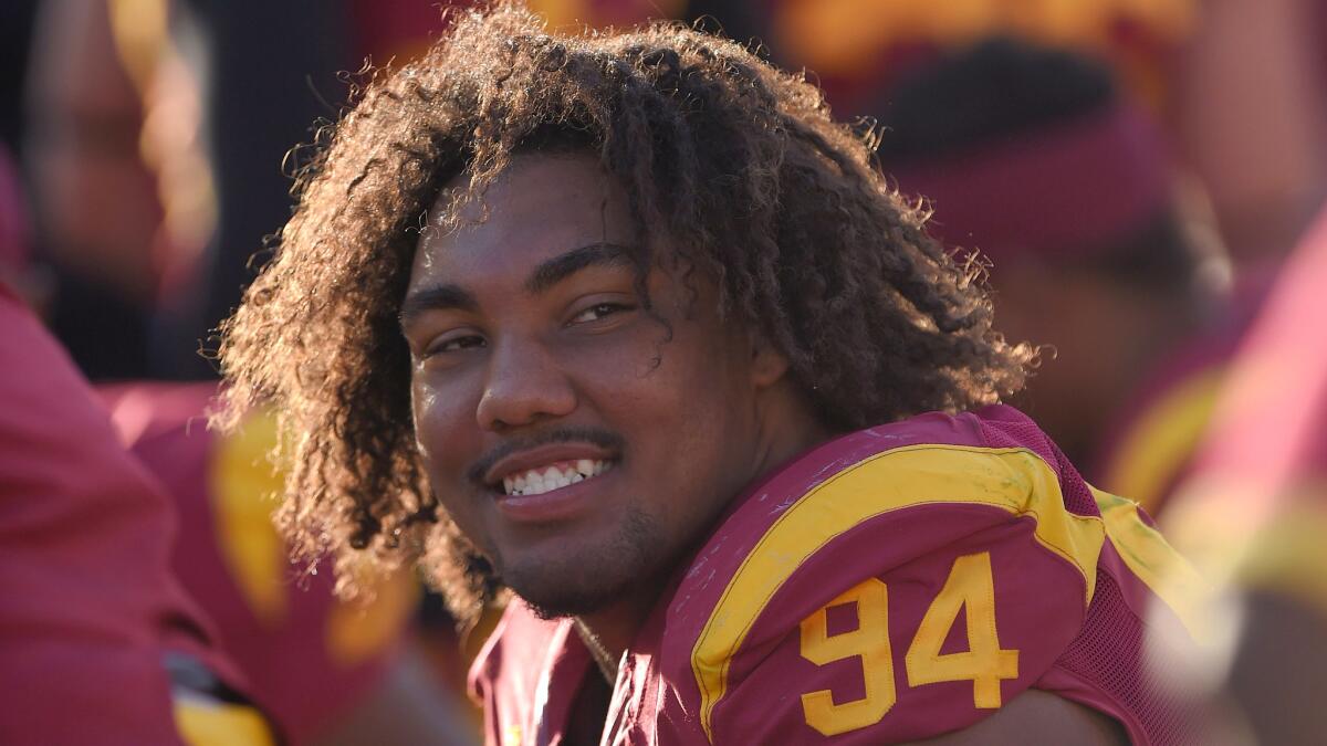 USC defensive end Leonard Williams smiles while sitting on the bench during a win over Notre Dame at the Coliseum last year.