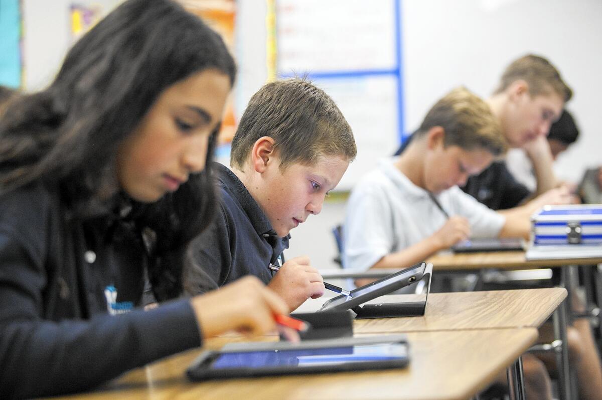 John Herold, 12, a student at Mariners Christian School uses an iPad.