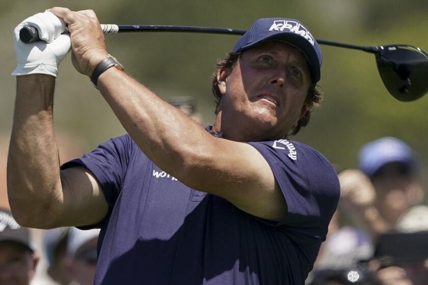 Phil Mickelson watches his tee shot on the 10th hole during a practice round for the U.S. Open Championship golf tournament, Tuesday, June 11, 2019, in Pebble Beach, Calif. (AP Photo/Carolyn Kaster)
