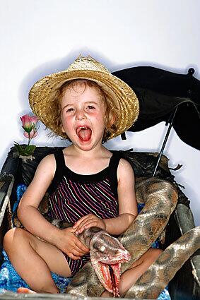 Pearl Coming, 2, of Oxfordshire, England, and her snake open wide.