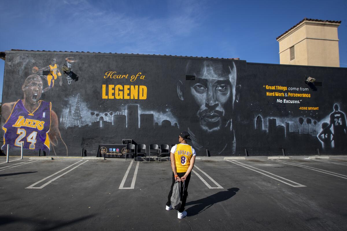 Frankie Becerra sports his Kobe Bryant Lakers jersey as he views The Watts Kobe Bryant Memorial Mural