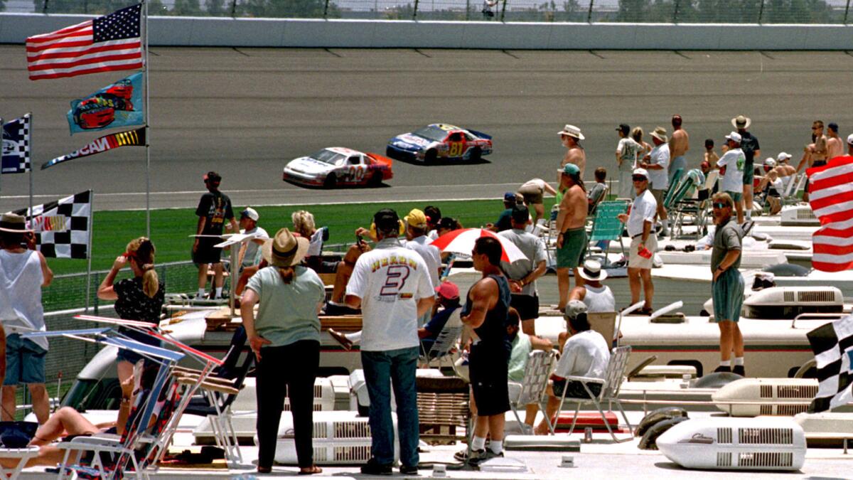NASCAR fans atop their RVs watch a Winston West race during Auto Club Speedway's inaugural year in 1997. (Reed Saxon / Associated Press)