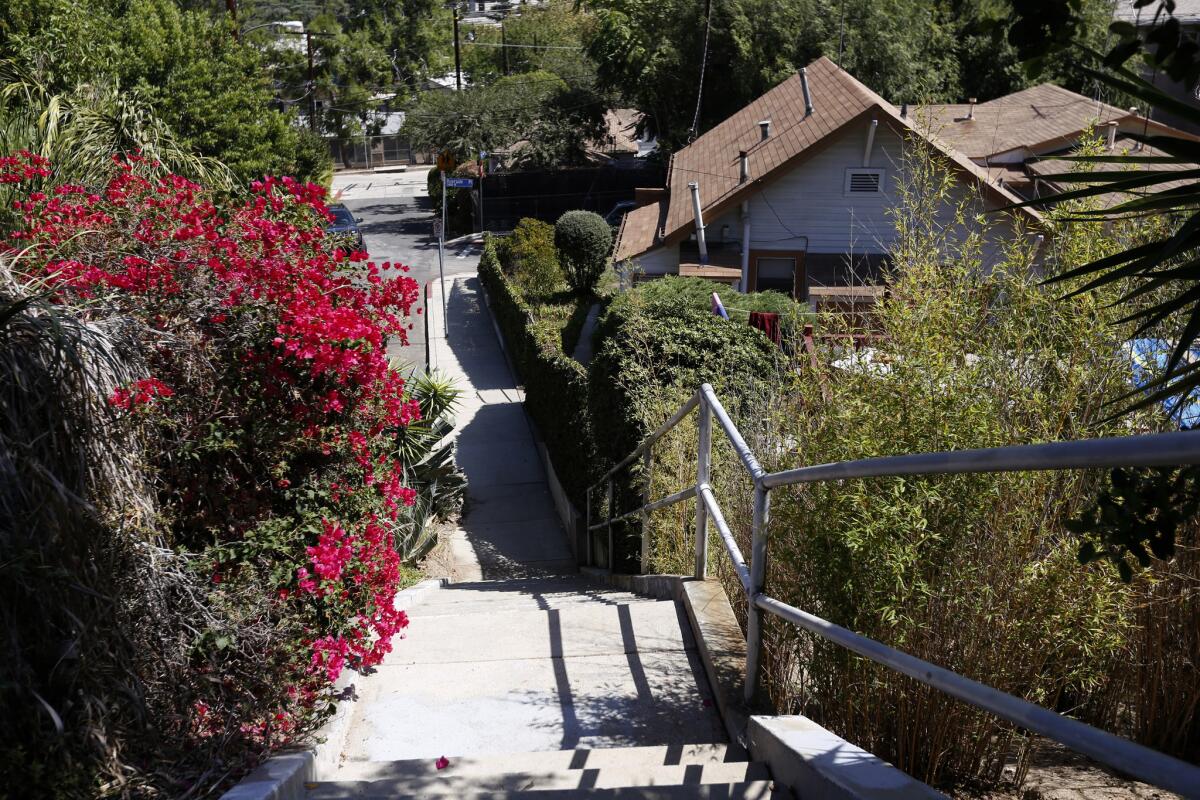 Public staircases, designed for pedestrian access to the trolley line, are on both sides of the road.