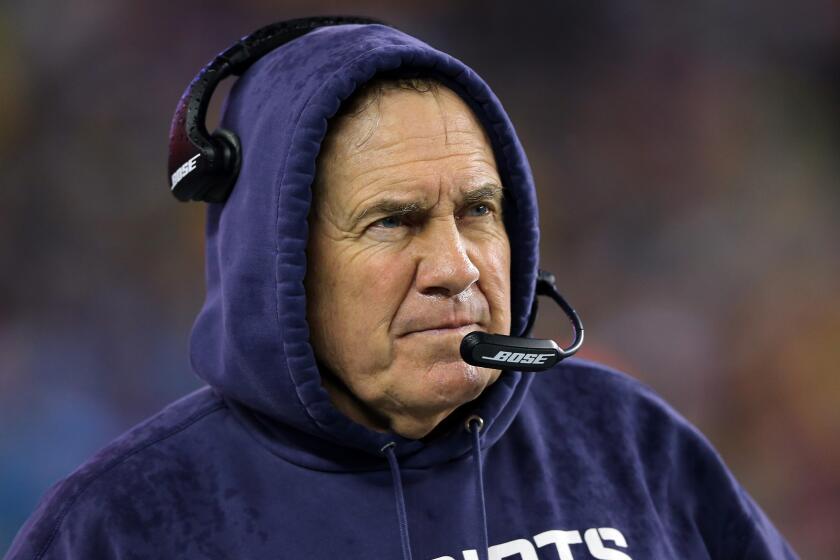 Coach Bill Belichick watches from the sideline during the New England Patriots' blowout win over the Indianapolis Colts in the AFC championship game on Sunday.