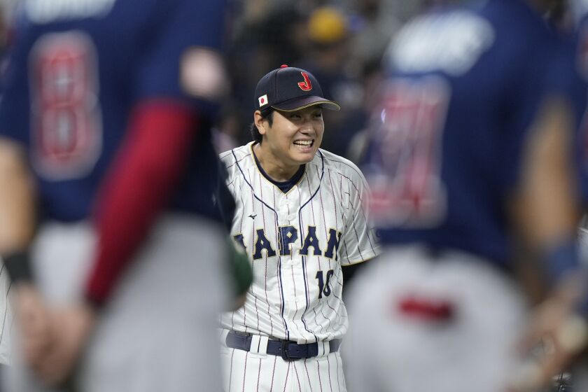 Japan player Shohei Ohtani (16) smiles during the player introduction before the World Baseball Classic championship game against the United States, Tuesday, March 21, 2023, in Miami. (AP Photo/Wilfredo Lee)
