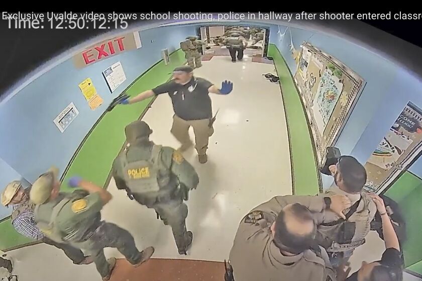 FILE - In this photo from surveillance video provided by the Uvalde Consolidated Independent School District via the Austin American-Statesman, authorities respond to the shooting at Robb Elementary School in Uvalde, Texas, on May 24, 2022. Nearly 400 law enforcement officials rushed to the mass shooting that left 21 people dead at the elementary school but “systemic failures” created a chaotic scene that lasted more than an hour before the gunman was finally confronted and killed, according to a report from investigators released Sunday, July 17, 2022. (Uvalde Consolidated Independent School District/Austin American-Statesman via AP, File)