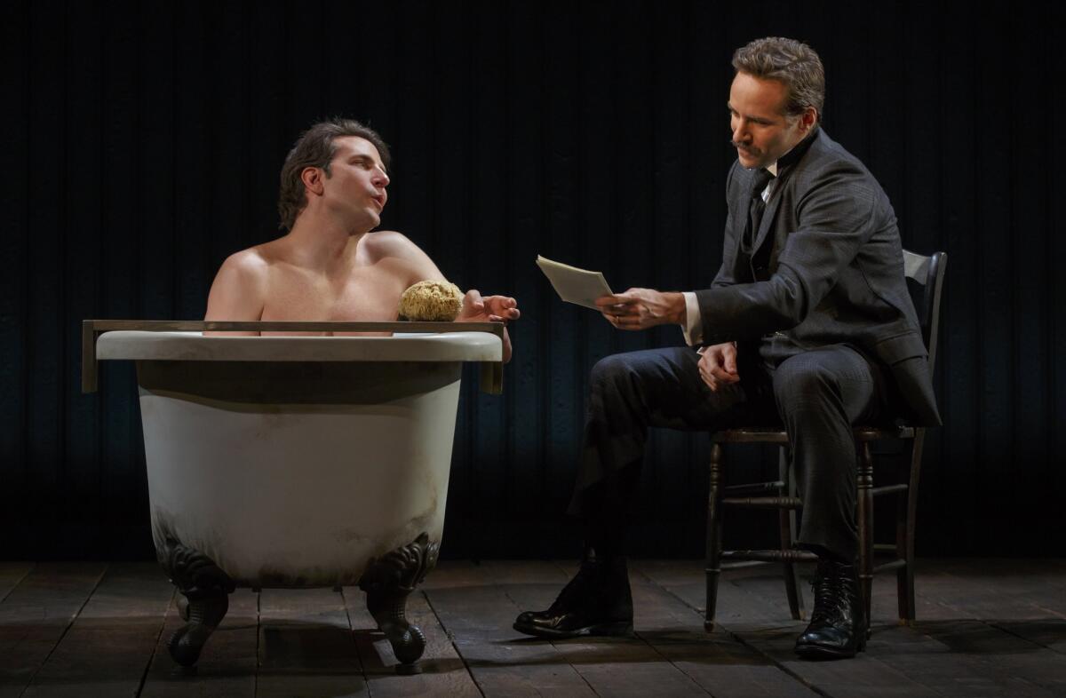 Bradley Cooper, left, and Alessandro Nivola star in "The Elephant Man" at the Booth Theatre in New York.