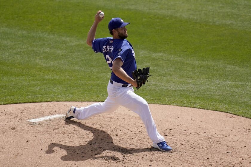 Los Angeles Dodgers starting pitcher Clayton Kershaw throws a pitch against the Milwaukee Brewers during the third inning of a spring training baseball game Tuesday, March 16, 2021, in Phoenix. (AP Photo/Ross D. Franklin)