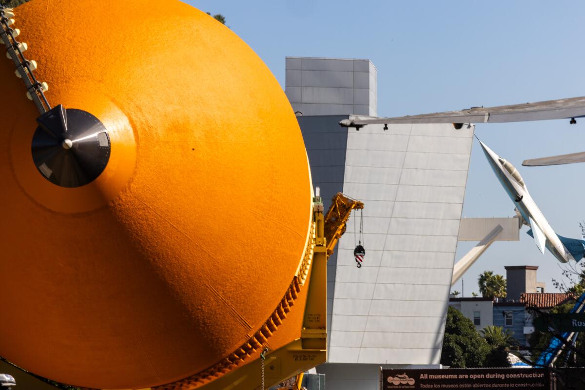 Space shuttle Endeavour's giant orange fuel tank is rolled into the California Science Center.