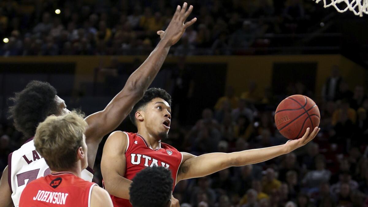 Utah guard Sedrick Barefield drives to the basket past Arizona State's De'Quon Lake, left, during the second half.