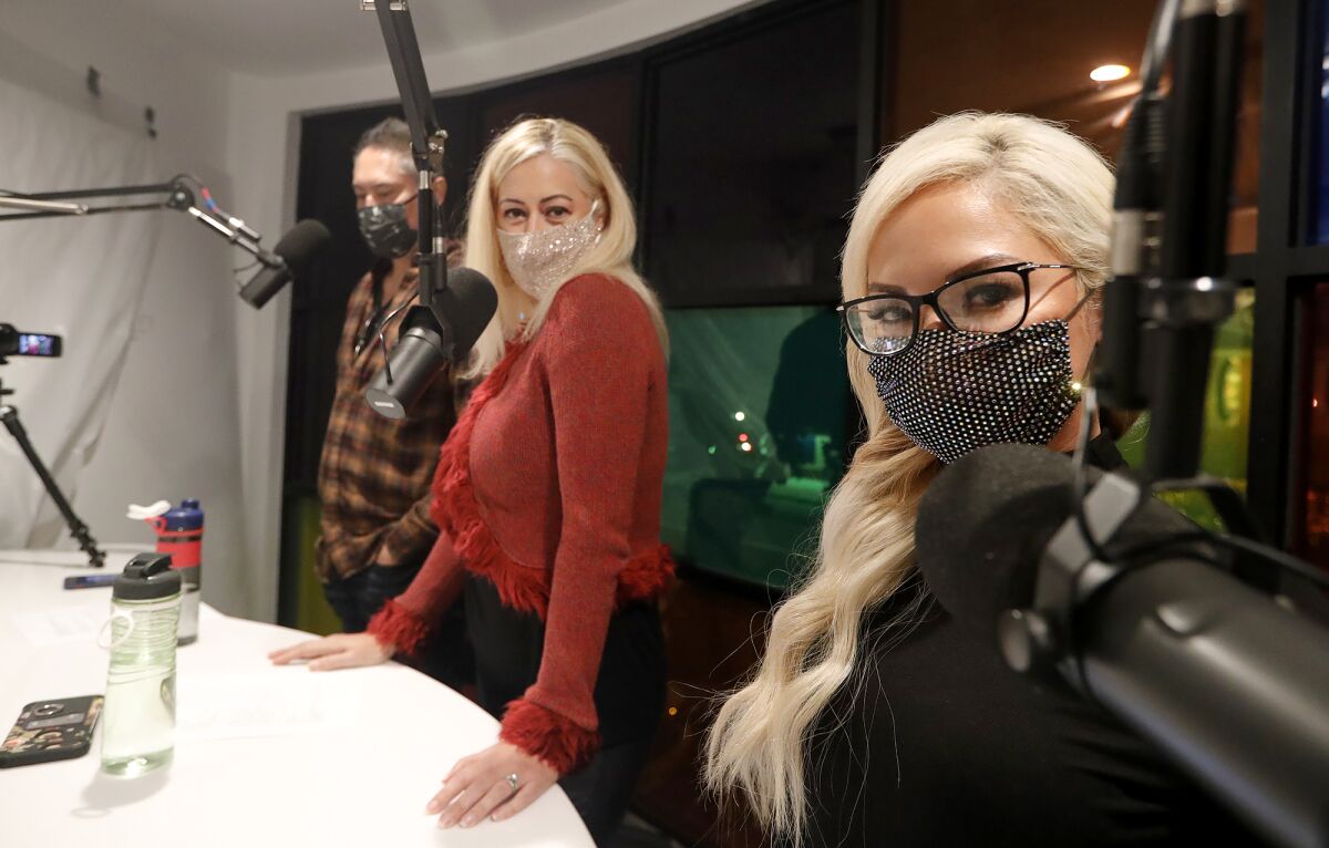 Frank and Krista Arellano, and Merry Tungka, from left, of Laguna Sound, pause as they participate in the KX Takeover.